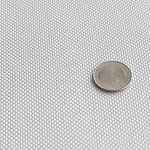 White fiberglass cloth with a plain weave and a quarter sitting on top for size reference.